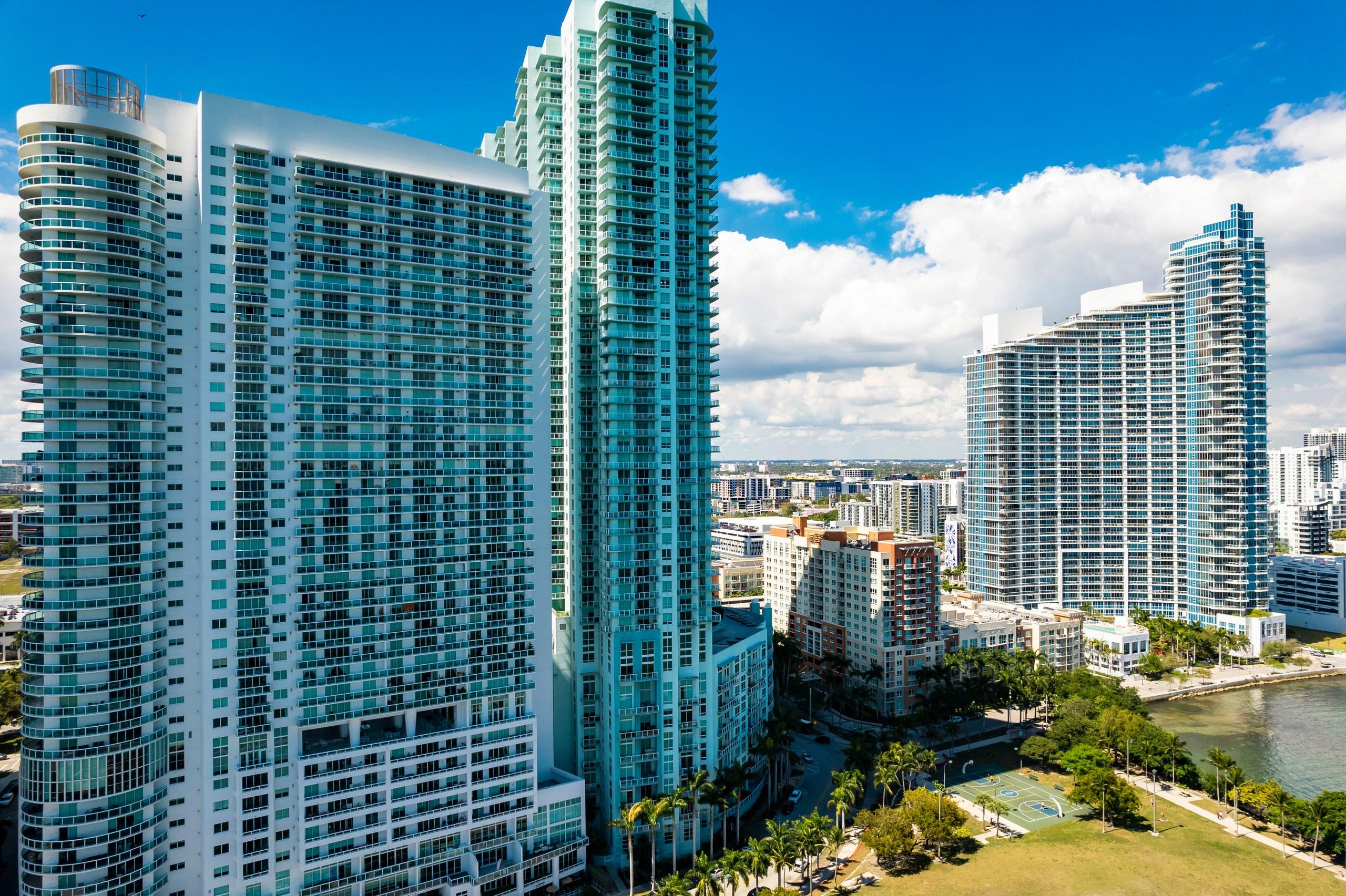Close aerial view of high-rise residential towers in the Edgewater neighborhood of Miami beside Biscayne Bay